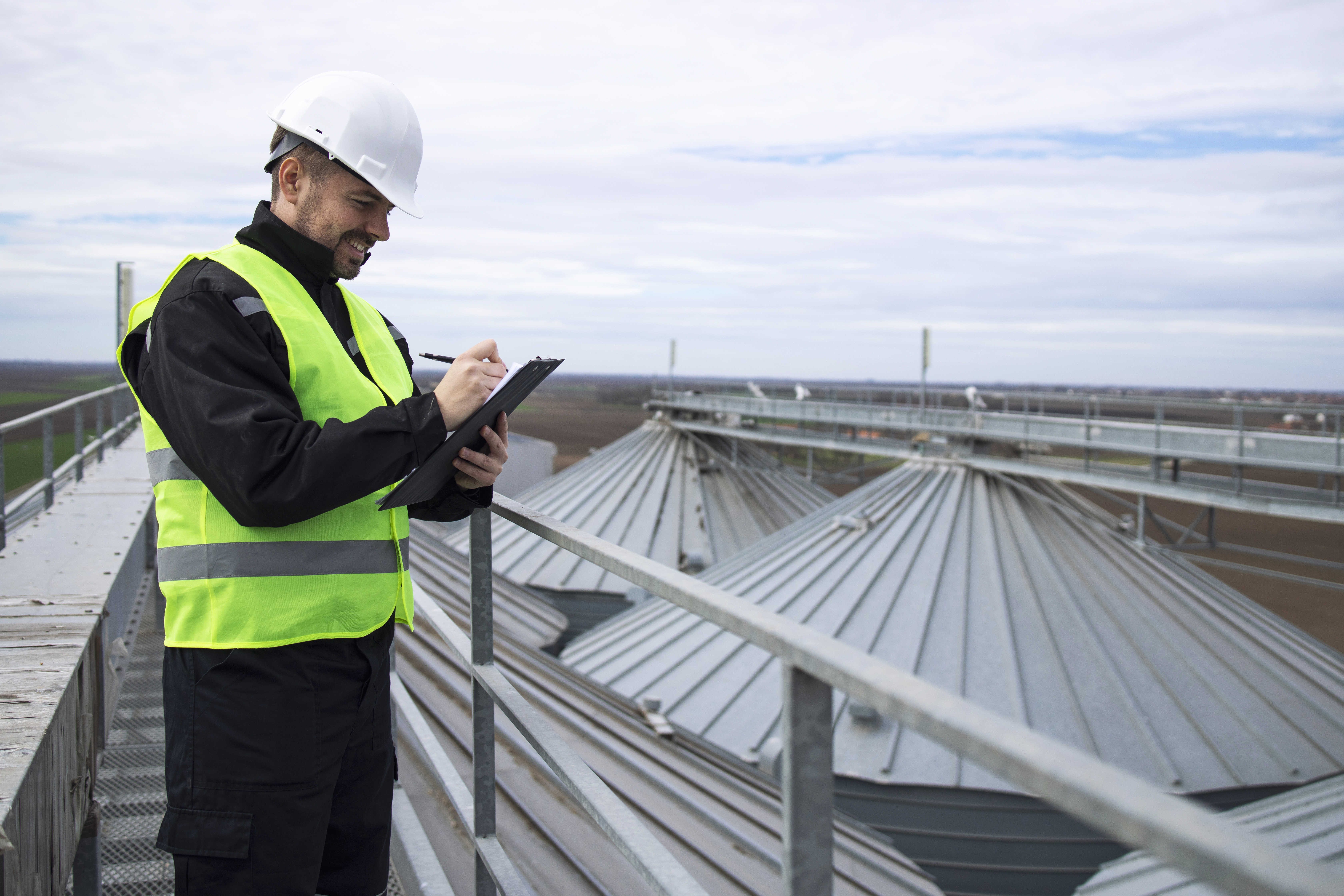 Inspector examining roof shingles